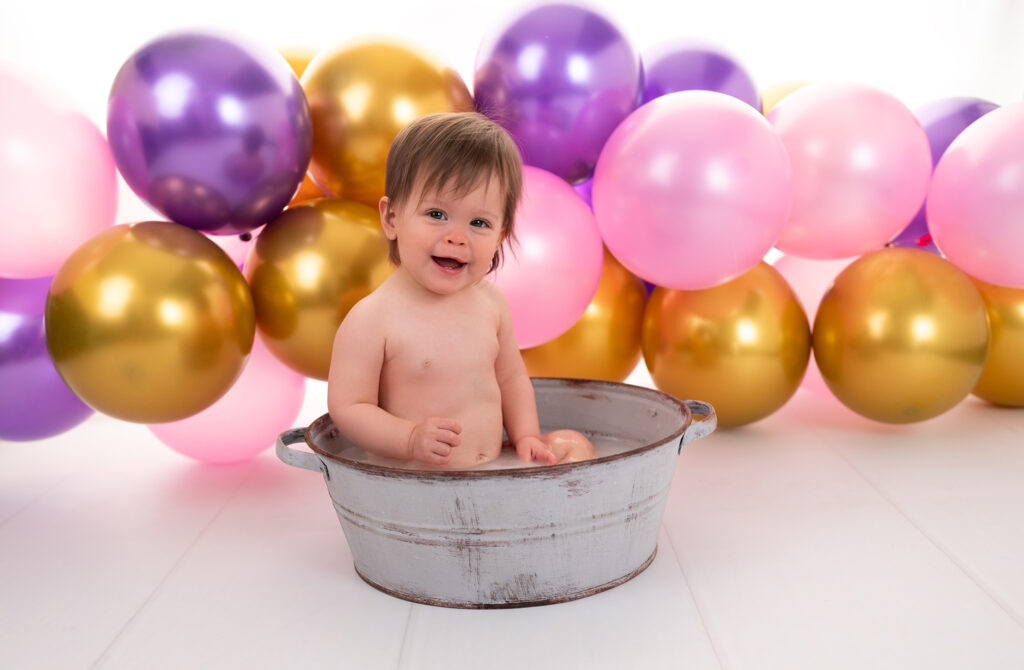 Petite fille de 1 an sourit dans son bain de lait Séance photo Smash the cake Houilles Yvelines photographe bébé Houilles photographe bébé Yvelines photographe bébé Ile-de-France photographe bébé Paris